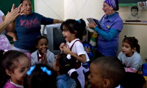 Cuban children and teachers celebrate after hearing Raúl Castro announce the restoration of relations with the US. Photograph: Ramon Espinosa/AP